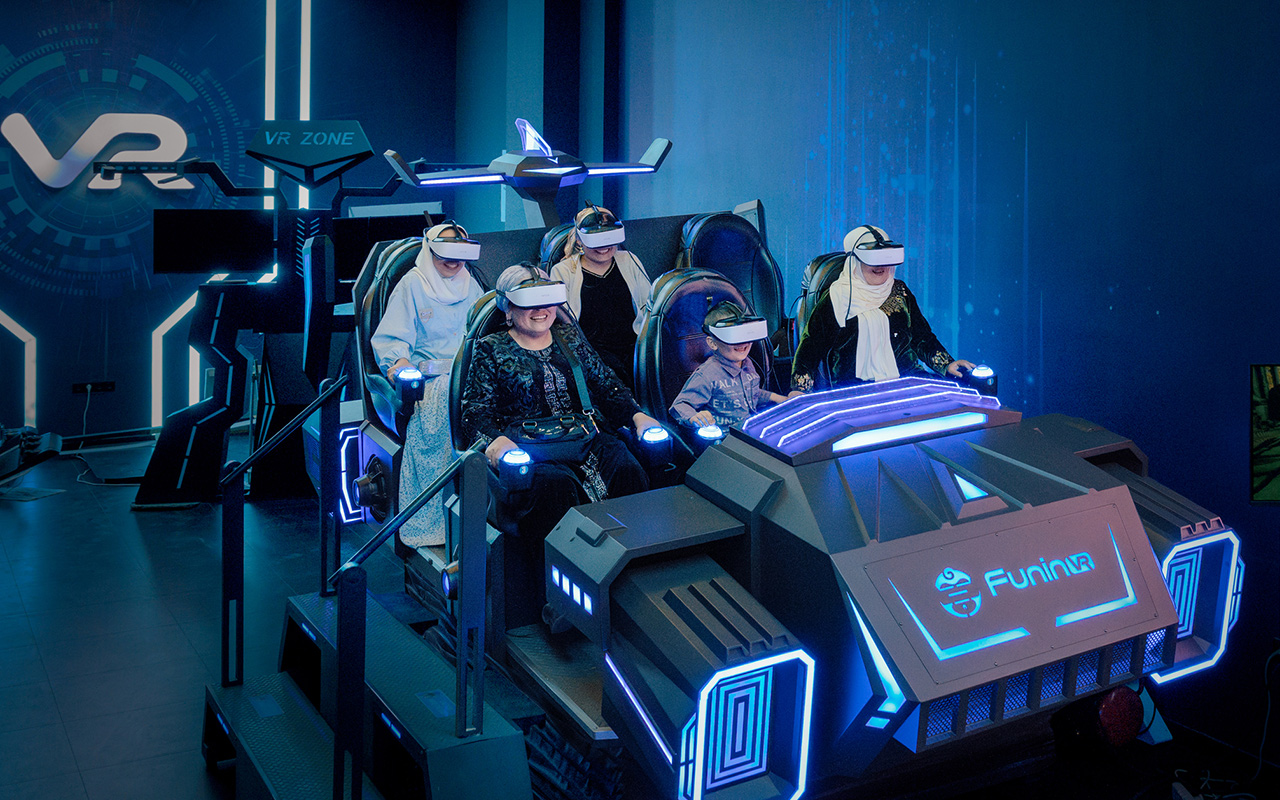 Visitors ride a virtual reality simulator at a new entertainment complex. 